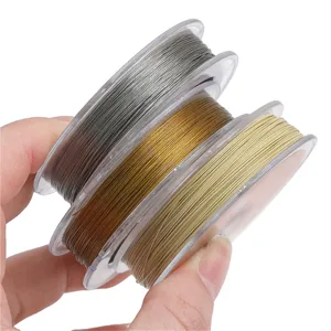 Close-up of three spools of 7-strand color-preserving steel wire in silver, gold, and bronze tones.