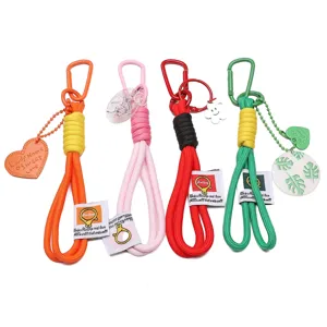 Handmade braided rope keychains in vibrant colors with carabiner and decorative charms