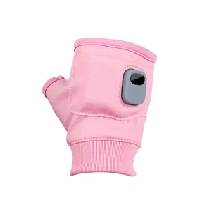 Detail view of a pink USB heated fingerless glove with power button