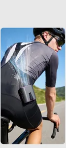 Close-up of a portable waist fan used by a cyclist for outdoor cooling