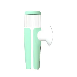 Side profile view showing the nozzle of a handheld eye nebulizer in mint green