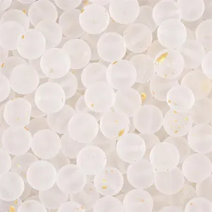 Macro detail of frosted white glass beads with embedded gold foil flakes for DIY jewelry.