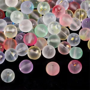 Detailed macro view of frosted jelly glass beads with gold foil for DIY jewelry