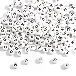 Detailed view of white round acrylic beads with black letters, including the word HAPPY.