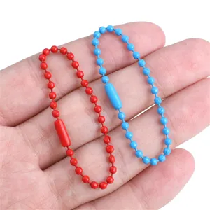 Close-up of red and blue painted iron ball chains for DIY jewelry and keychains.