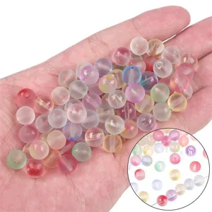 Close-up macro view of colorful translucent jelly glass beads with gold glitter for DIY crafts