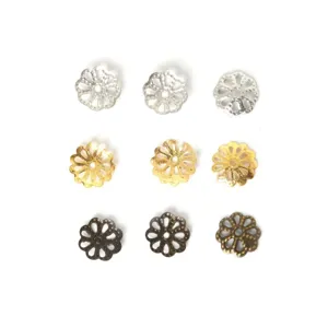 Macro detail of ornate filigree flower bead caps in silver gold and bronze metal finishes