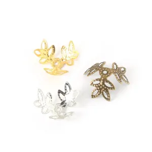 Detailed view of three-color leaf-shaped filigree bead caps for DIY jewelry making
