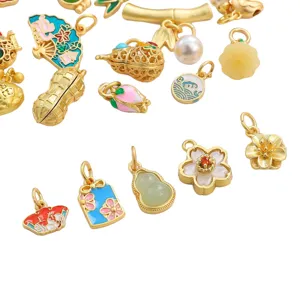 Assorted gold-plated enamel charms with floral and traditional motifs for DIY jewelry.