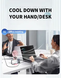 Pink portable USB mini fan with digital display used in an office meeting desk setting