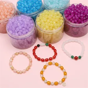 Colorful 8x10mm glass beads for DIY jewelry making with finished bracelets on pink background