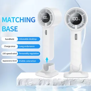 Close-up of white portable handheld mini fan with charging base and LED power display