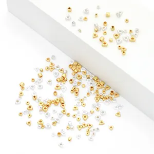 Detailed view of 14K gold filled and silver triangle and cube spacer beads for jewelry