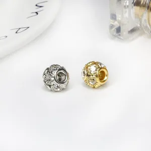 Close-up detail of gold and silver hollow rhinestone beads for DIY jewelry making