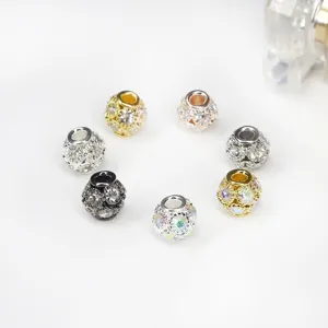 Close-up of sparkling rhinestone hollow spacer beads in assorted metal finishes