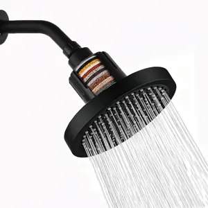 Close-up of 6-inch matte black filtered shower head showing powerful water spray