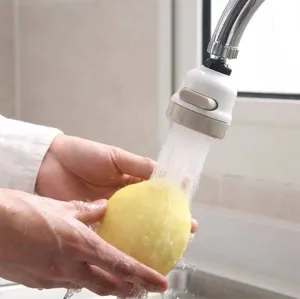 3-mode rotatable kitchen faucet aerator extender spraying water on fruit in a sink