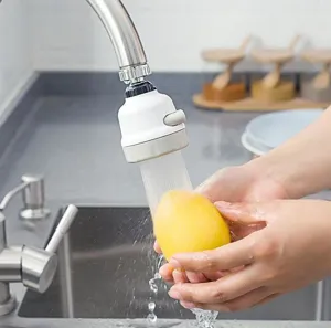 Professional close-up of a rotatable 3-mode faucet aerator washing fruit in kitchen sink