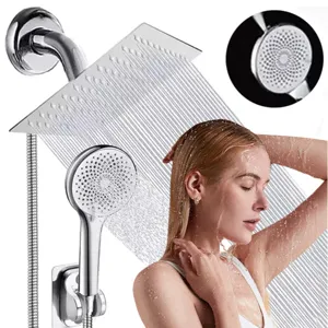 Close-up detail of stainless steel shower head set with top spray and handheld in use