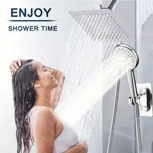 Close-up detail of stainless steel rainfall shower head and handheld sprayer with water flow