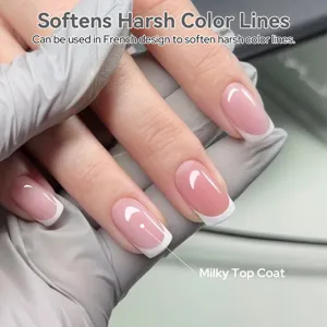 Close-up of milky top coat nail polish applying a soft finish for French manicure