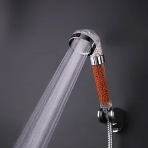Detail view of filtering shower head with mineral beads and high pressure water flow