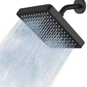 Close-up detail of a matte black 6-inch square shower head with powerful water spraying