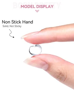 Detailed macro view of clear solid non-stick nail extension gel pinched between fingers