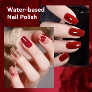 Water-based red nail polish with heart patterns and gold glitter accents for a stylish look