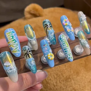 Detail of 3D summer ocean theme press-on nails featuring dolphins and lifebuoys