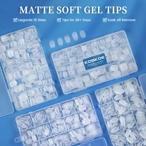 Detailed view of matte frosted soft gel nail tips in organized plastic storage boxes
