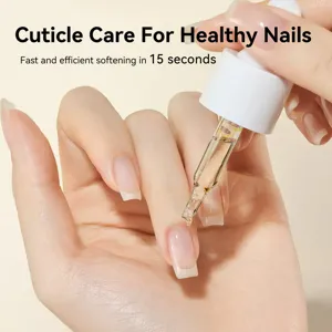 Close-up of cuticle oil application with a dropper for healthy nails