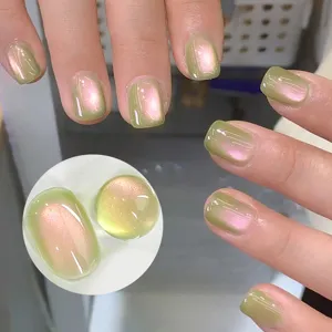 Guava green cat eye nail polish with aurora pink shimmer and glass bead effect on nails.