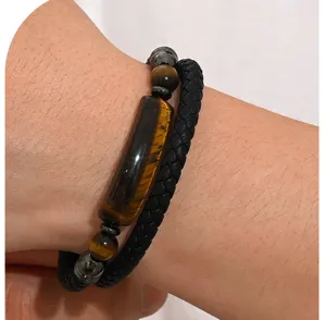 Close-up of men's double-row braided leather bracelet with natural tiger eye stone