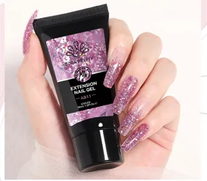 Detail showing a tube of BORN PRETTY glitter pink extension nail gel held in hand
