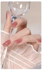 Gros plan d'un vernis à ongles gel rose nude translucide avec fini brillant