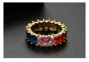 Close-up of rainbow cubic zirconia ring with gold plating and emerald cut stones.