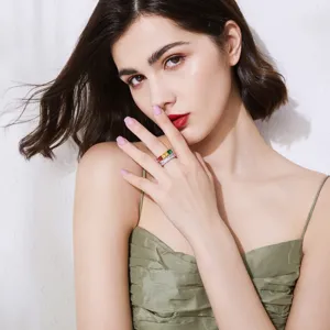 Elegant vintage rainbow zircon ring with emerald-cut colorful stones worn by a model