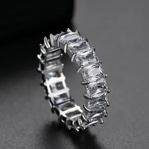 Sparkling eternity ring with emerald-cut cubic zirconia in elegant silver-tone setting.
