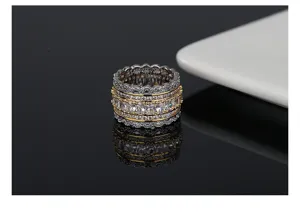 Macro detail of a hip hop style two-tone ring with sparkling full-set crystals