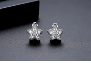 Detailed view of dainty silver star stud earrings with sparkly micro-pave cubic zirconia stones