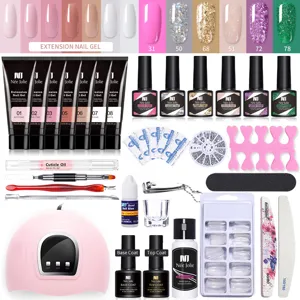Vista completa del kit profesional de gel de extensión de uñas con lámpara UV y útiles