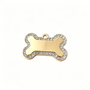 Gold rhinestone bone pet dog tag pendant, sparkly crystal metal puppy accessory detail.
