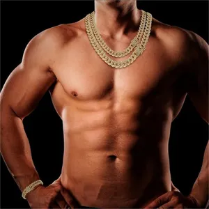 Close-up of a male model wearing two iced out gold Cuban link chains and a bracelet