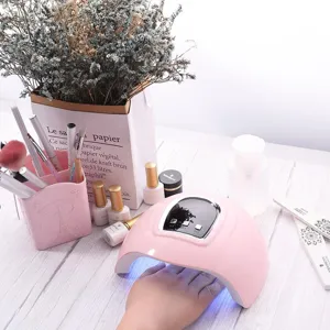54W UV LED nail dryer lamp shown in a pink themed professional manicure setting