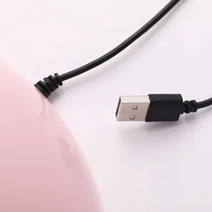 Macro detail showing the black USB connector and cable for the pink LED nail lamp.