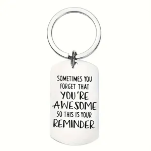 Macro detail of a stainless steel keychain with engraved inspirational quote reminder