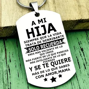 Close-up of a stainless steel dog tag keychain with Spanish inspirational quote for daughter