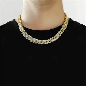 Close-up detail of a men's iced-out gold-plated Cuban link chain hip hop necklace