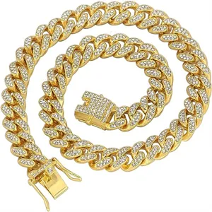 Macro close-up of a gold-plated iced-out Cuban link necklace with clear rhinestones.
